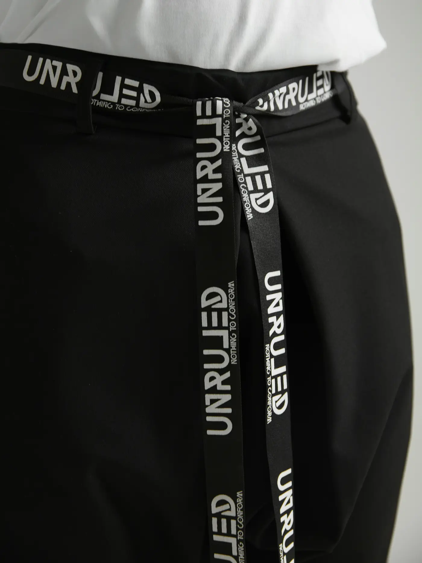 Macro detail of the branded ribbon belt