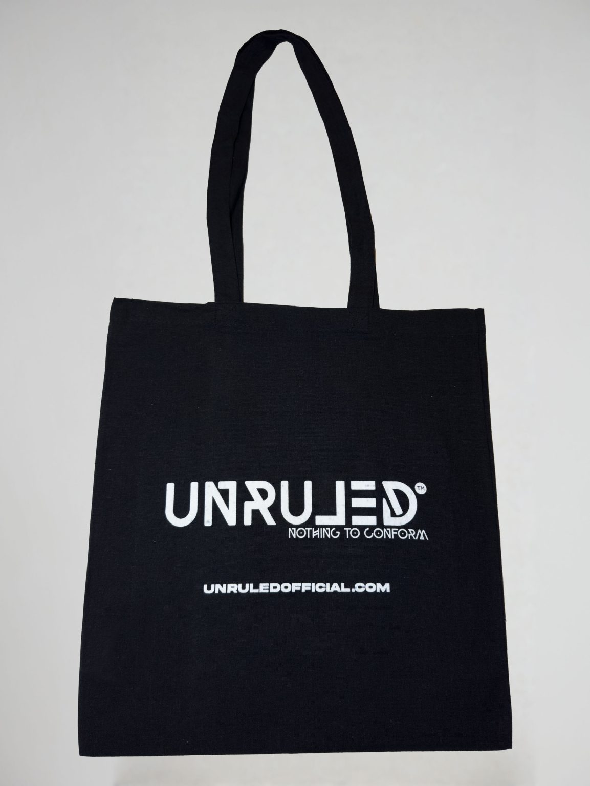UNRULED eco-friendly reusable shopper bag featuring minimalist branded design.