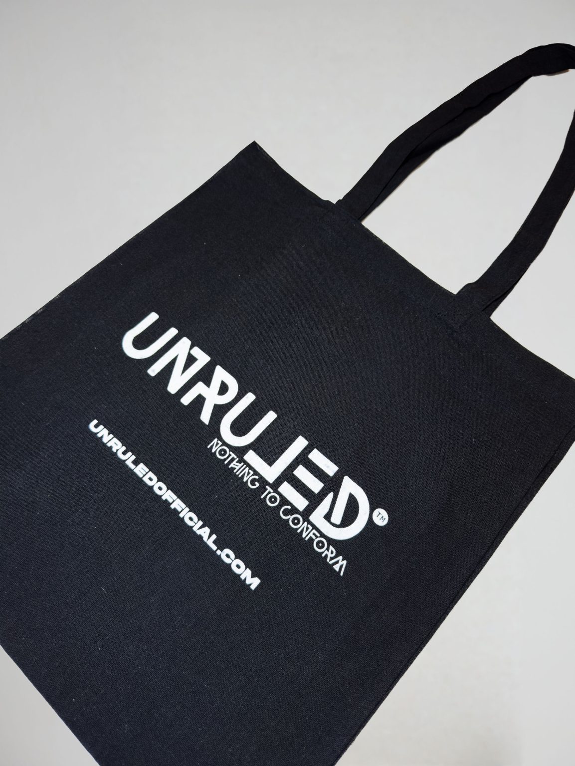 Black UNRULED tote bag designed for sustainable everyday use and shopping.