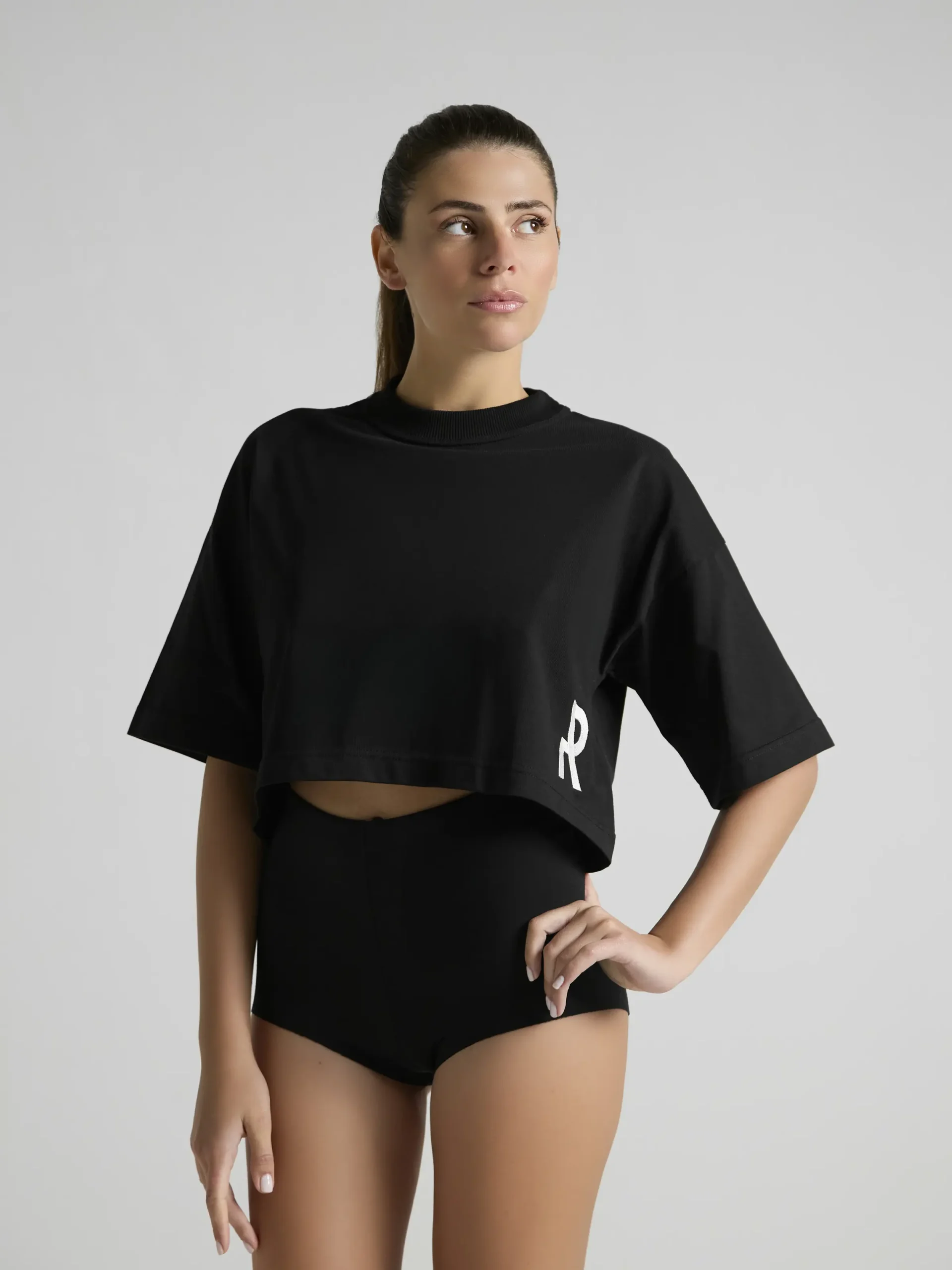 Black cropped T-shirt featuring a minimalist contemporary design by UNRULED.