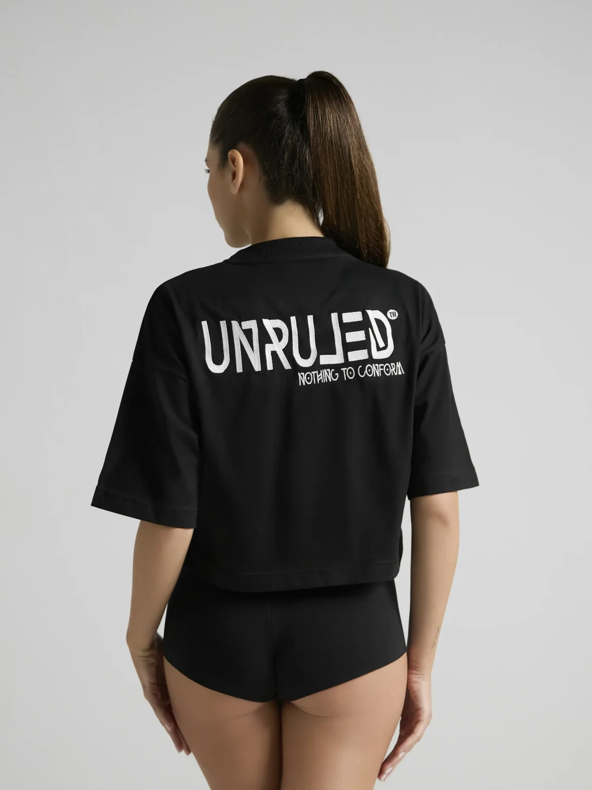 Black cropped T-shirt featuring a minimalist contemporary design by UNRULED.