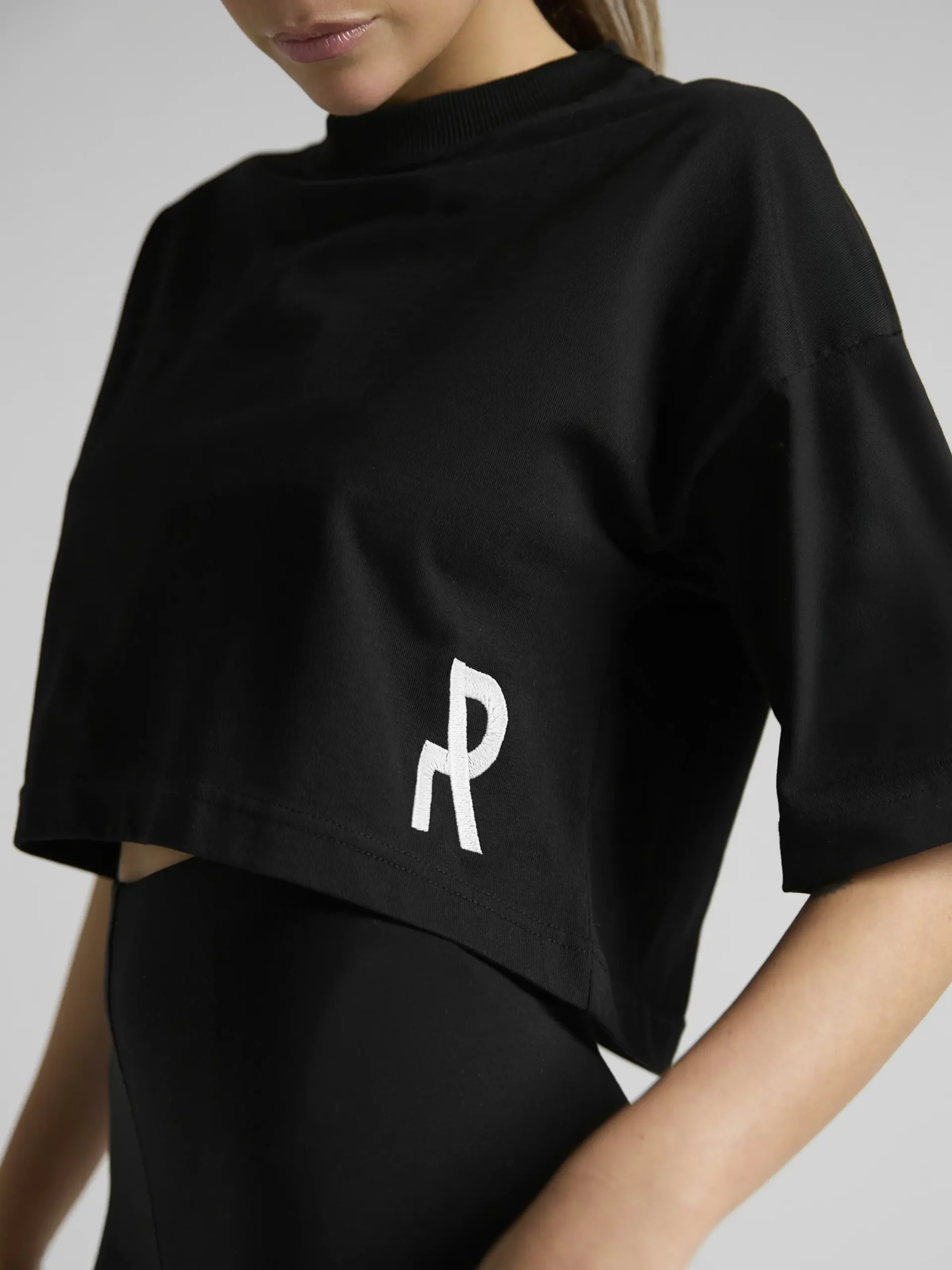 Minimalist women's streetwear styling with the UNRULED black crop top.