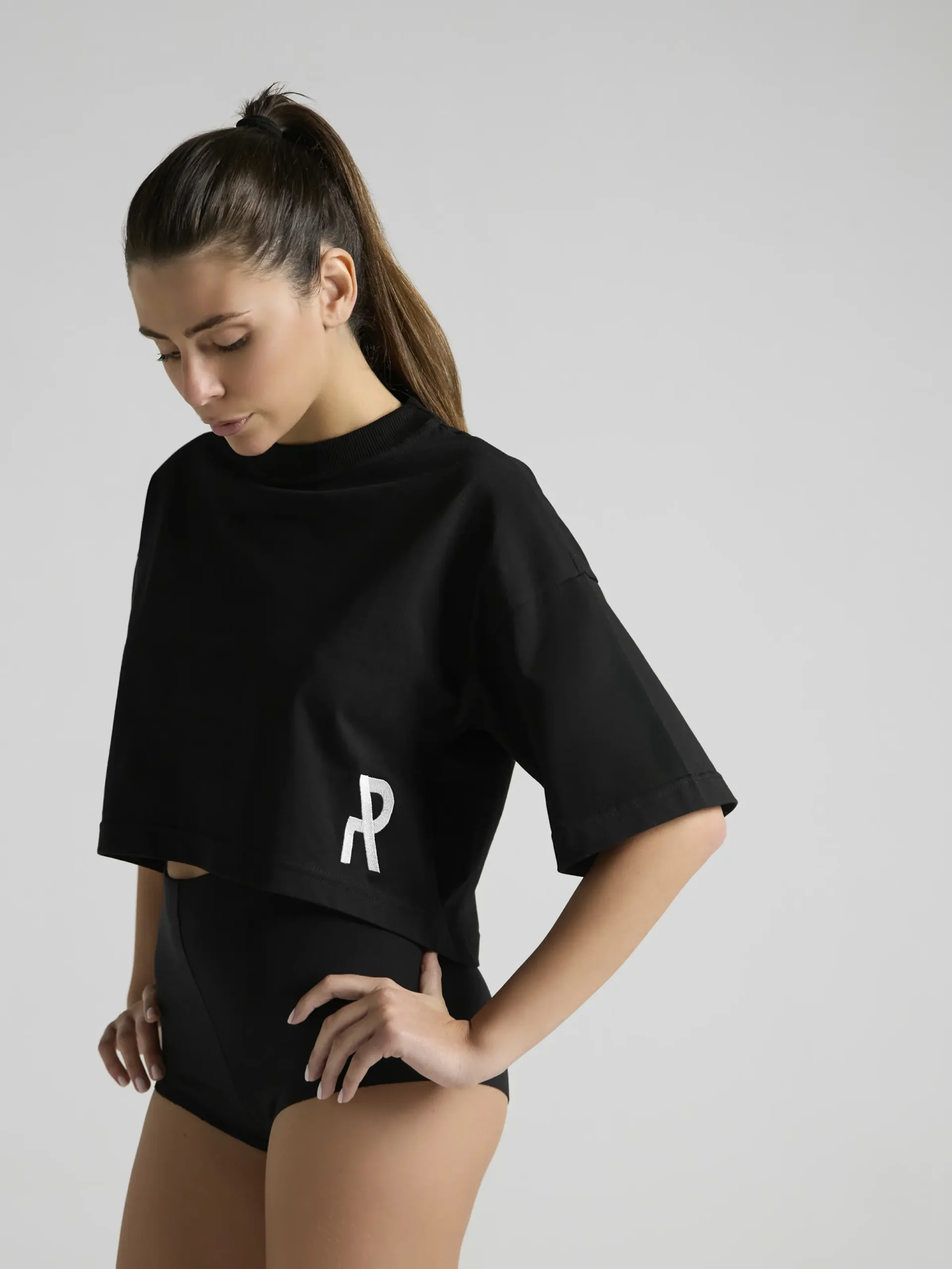 Minimalist women's streetwear styling with the UNRULED black crop top.