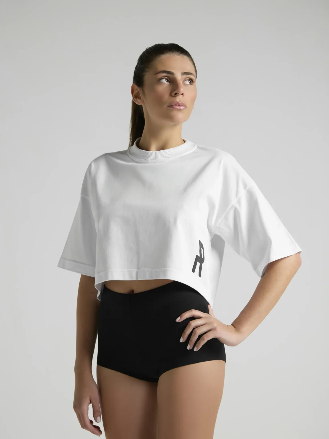 UNRULED white cropped t-shirt for women with clean and versatile styling.