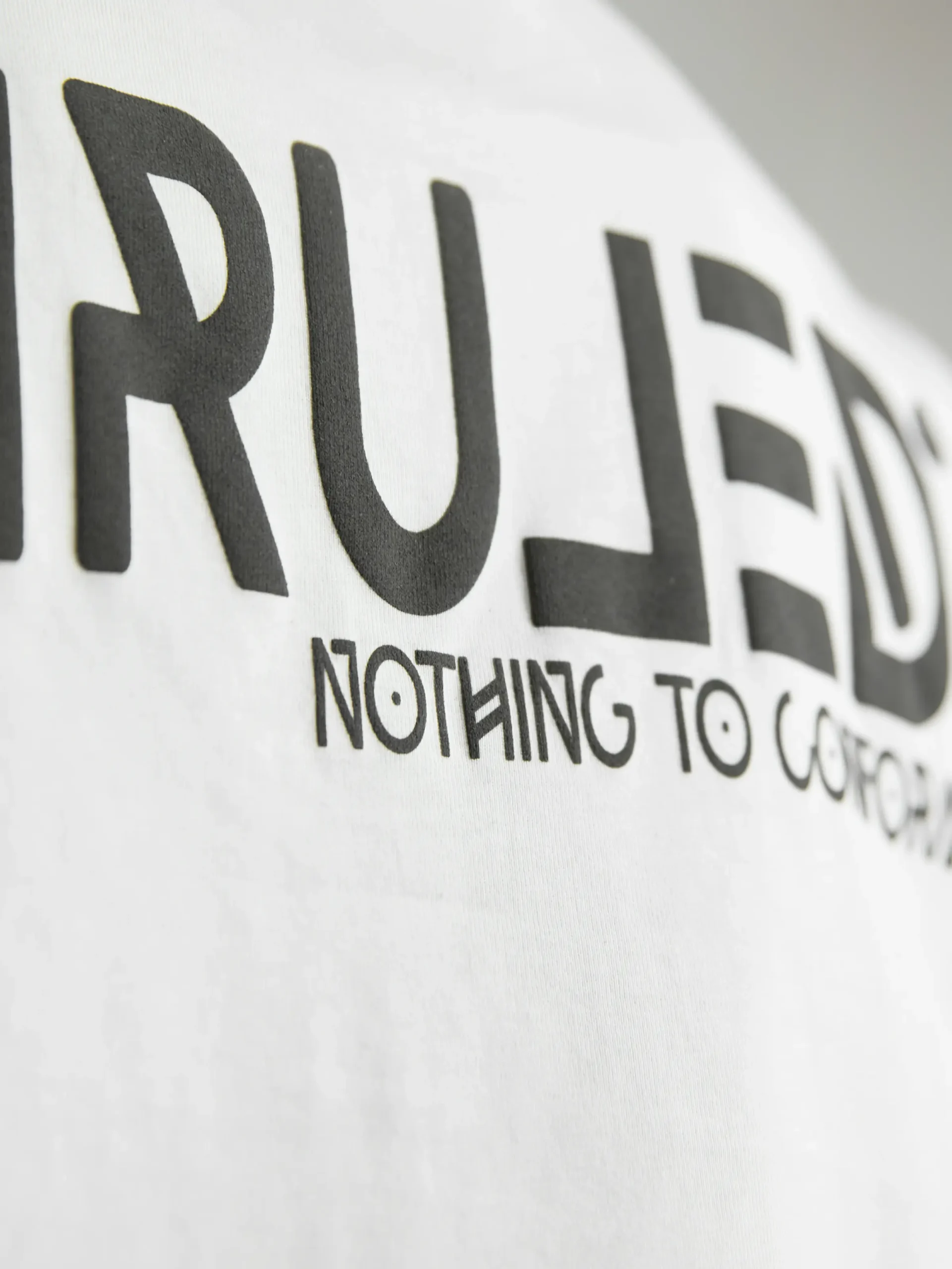 UNRULED white cropped t-shirt for women with clean and versatile styling.