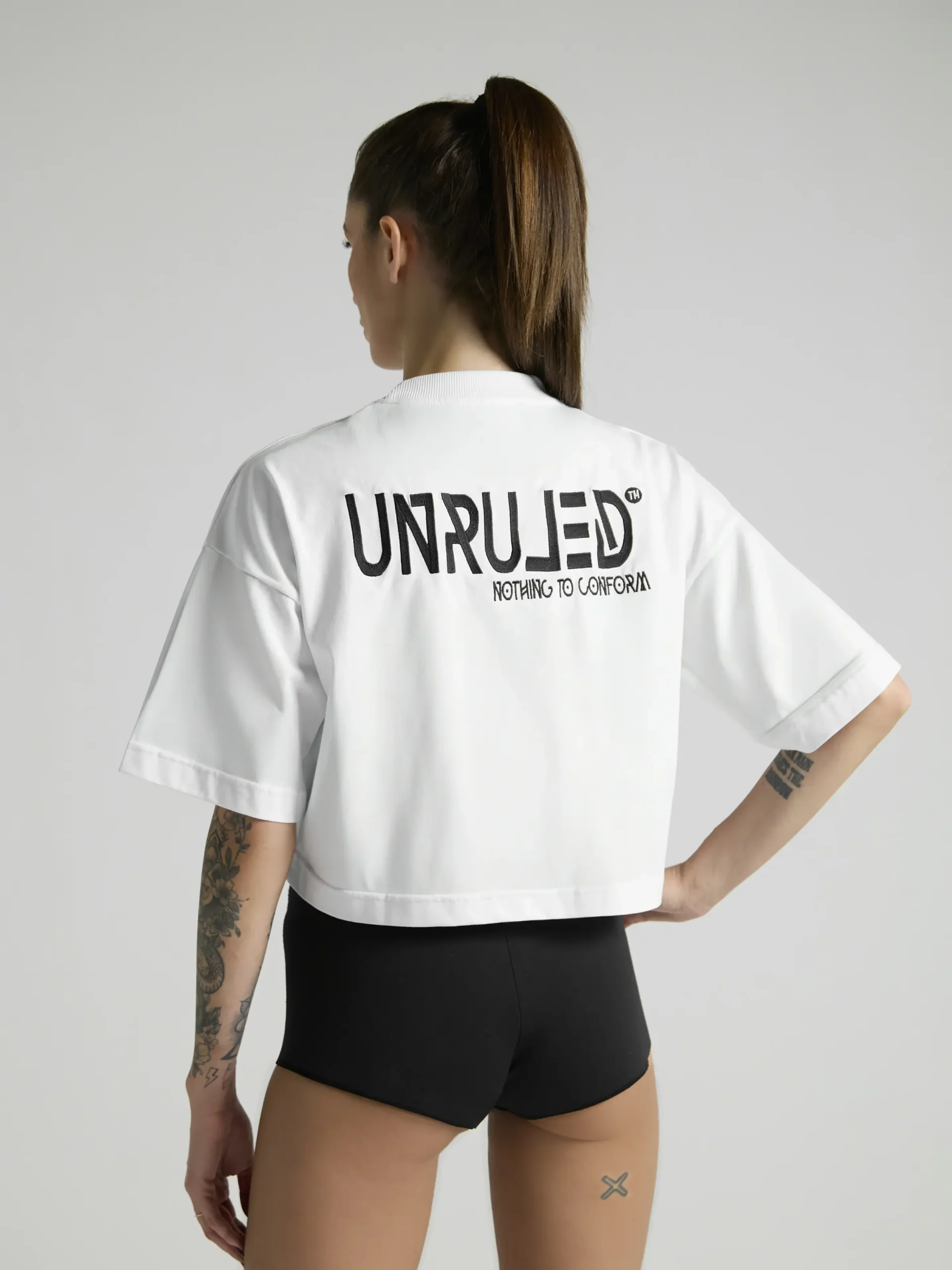 Women's white crop top with premium fabric and fitted silhouette by UNRULED.