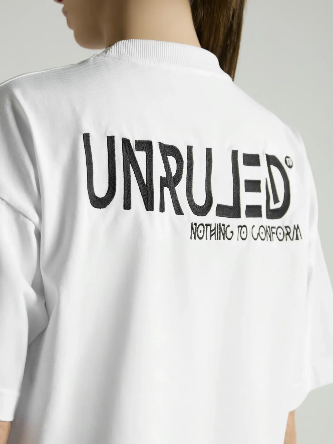 Women's white crop top with premium fabric and fitted silhouette by UNRULED.