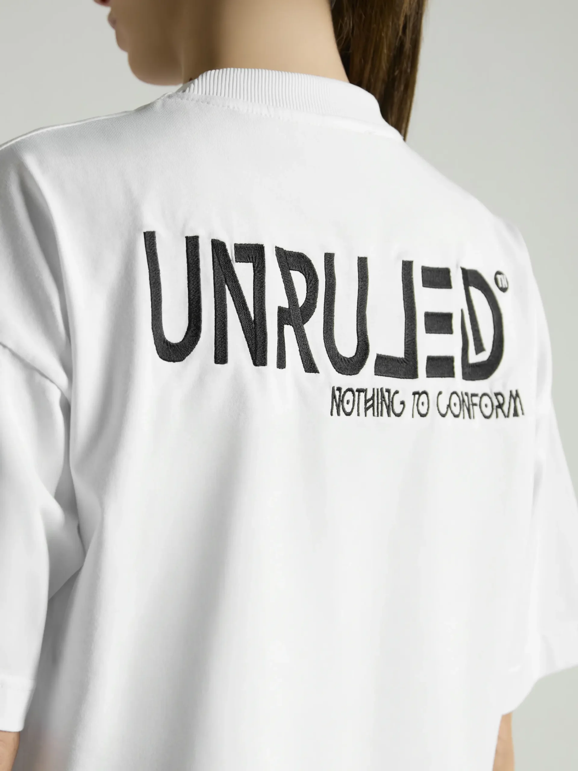 Women's white crop top with premium fabric and fitted silhouette by UNRULED.