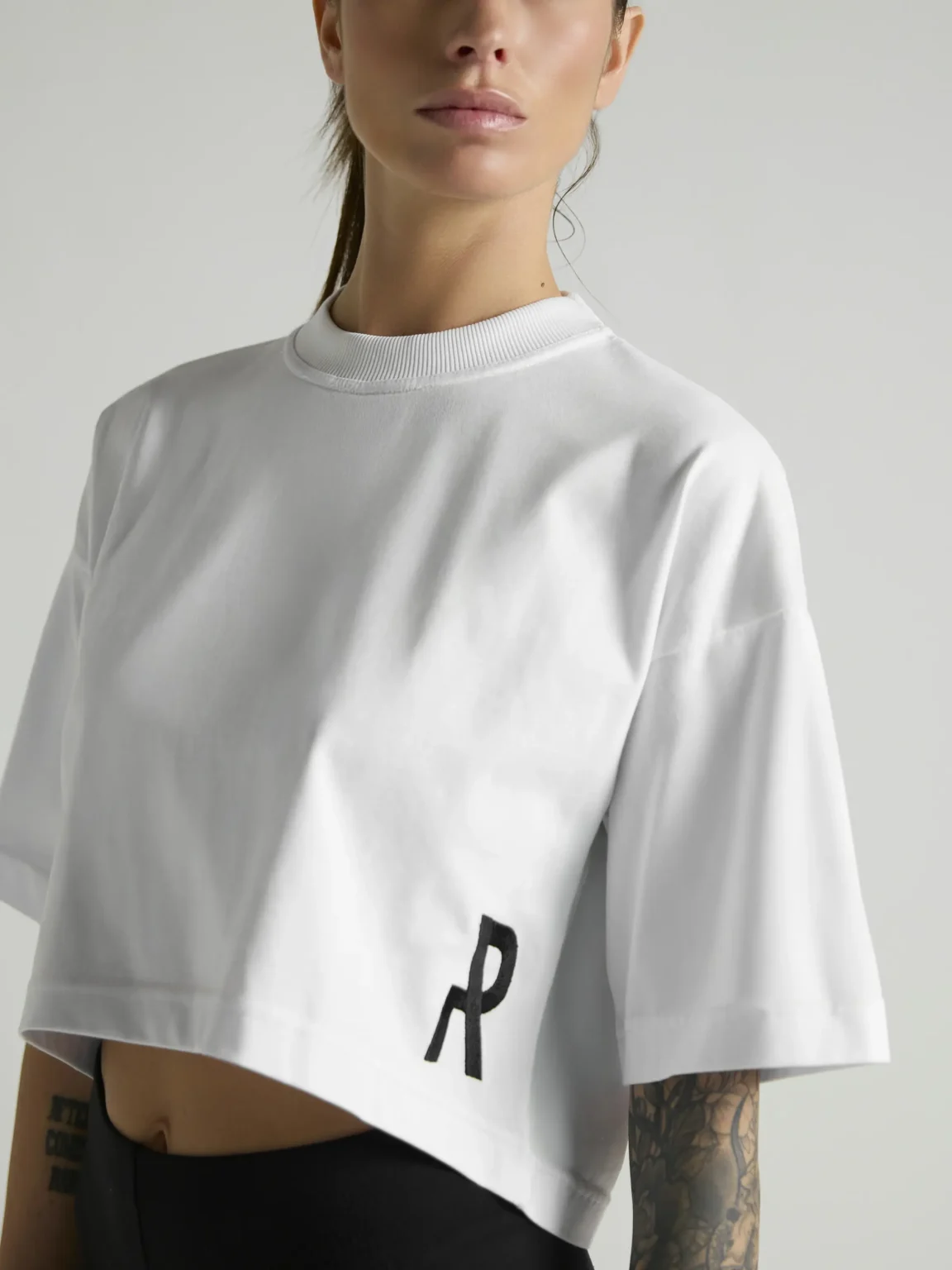 Women's white crop top with premium fabric and fitted silhouette by UNRULED.