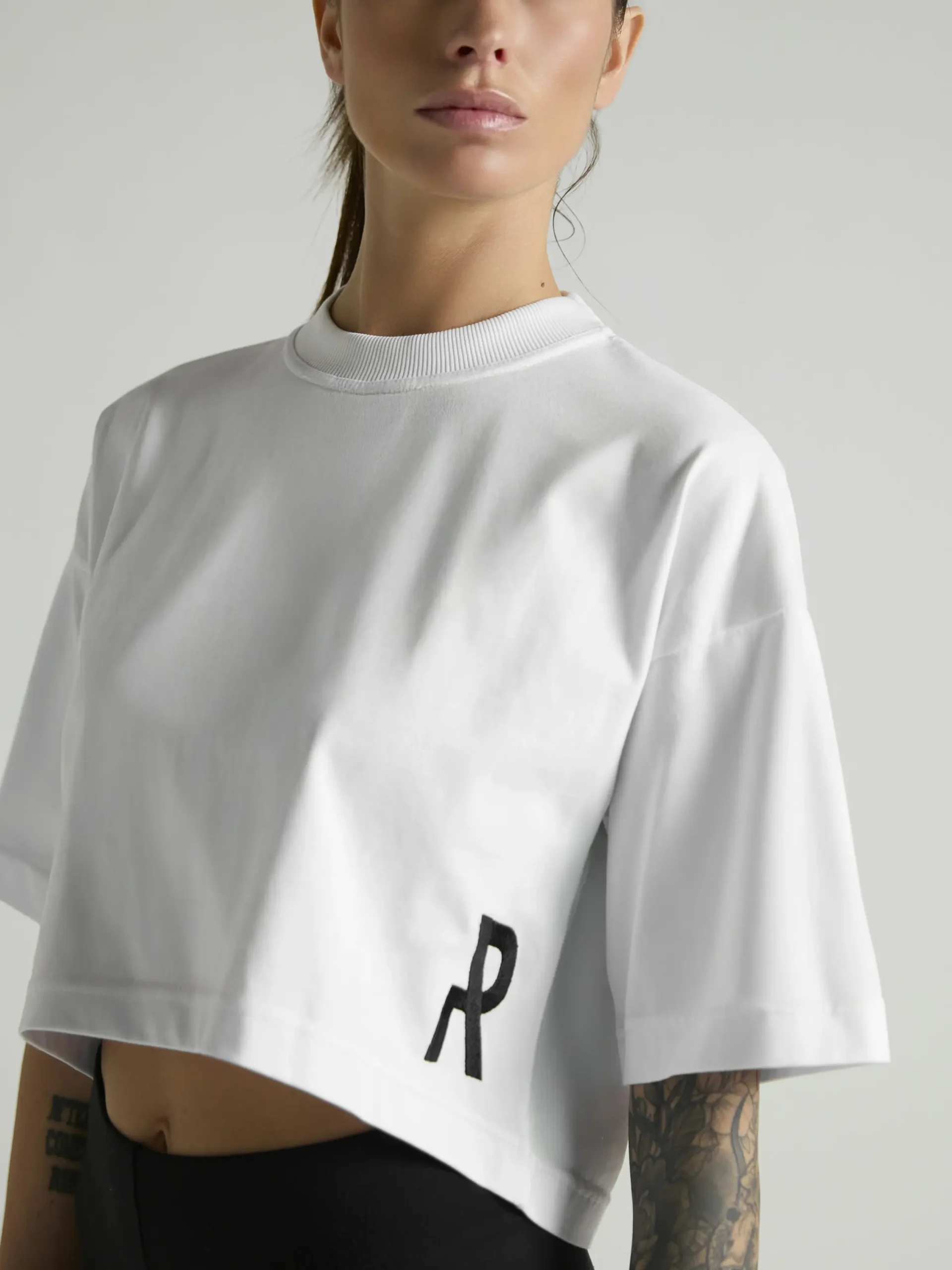 Women's white crop top with premium fabric and fitted silhouette by UNRULED.