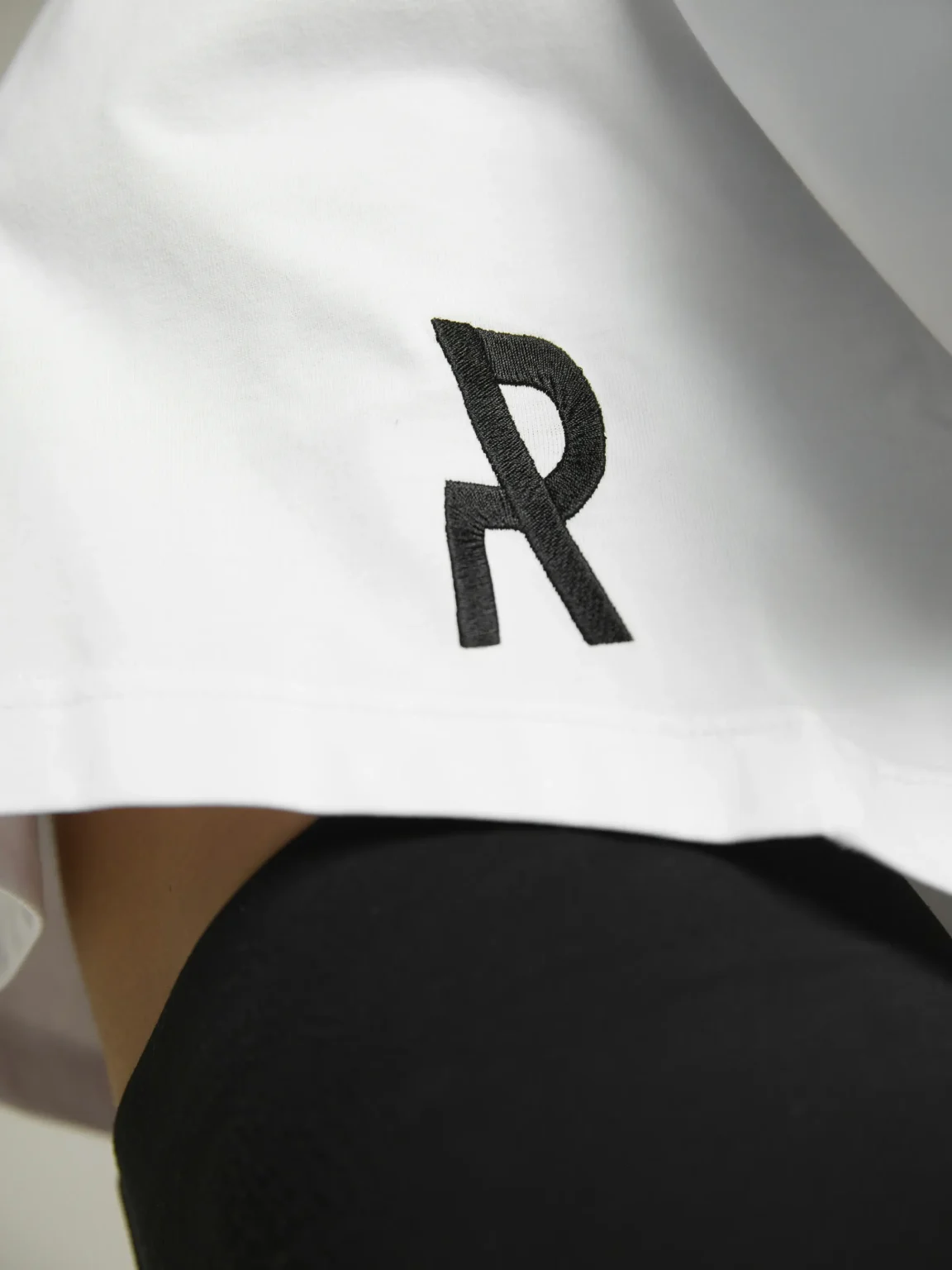 Women's white crop top with premium fabric and fitted silhouette by UNRULED.