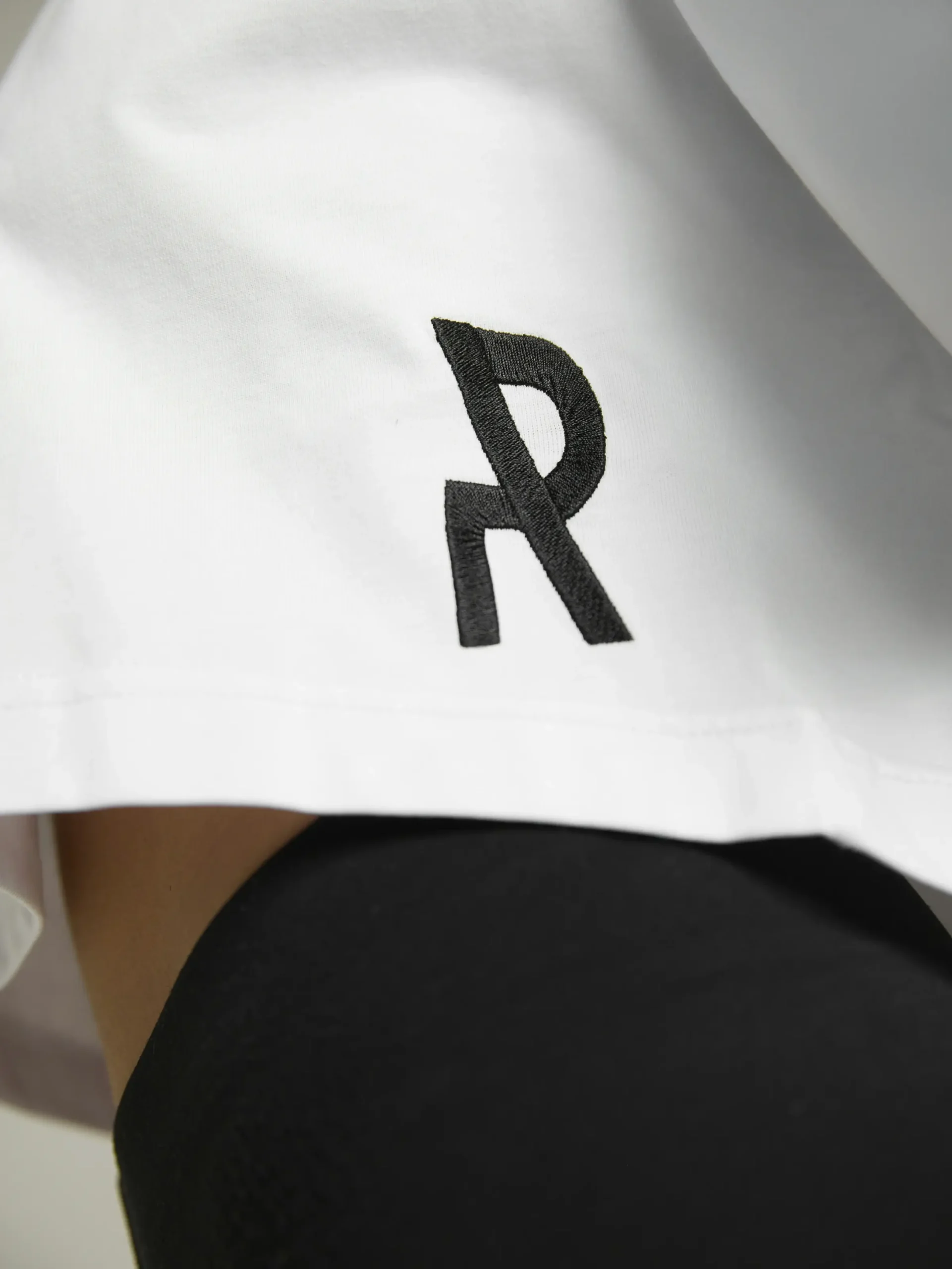 Women's white crop top with premium fabric and fitted silhouette by UNRULED.