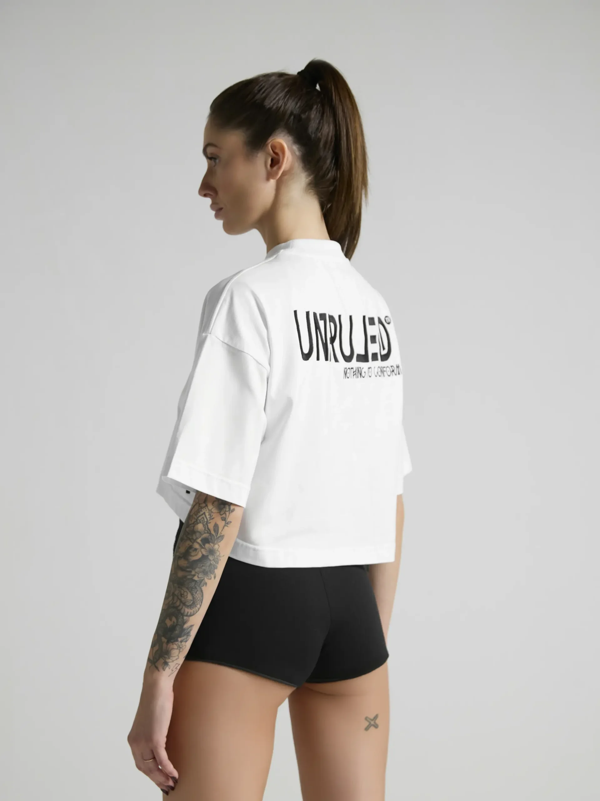 Women's white crop top with premium fabric and fitted silhouette by UNRULED.