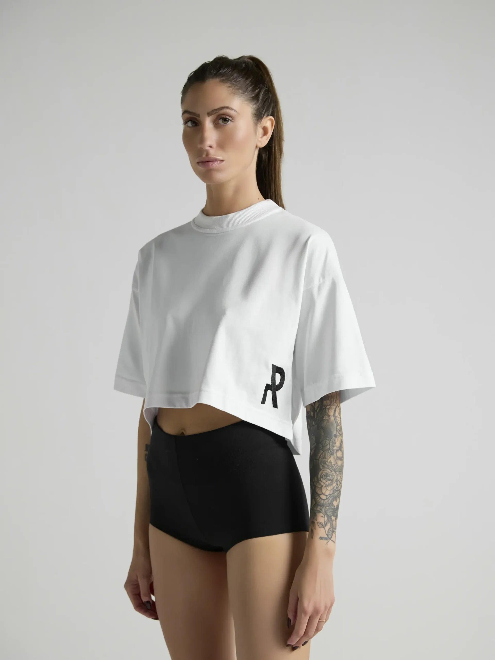 UNRULED white crop top combining comfort and contemporary style.