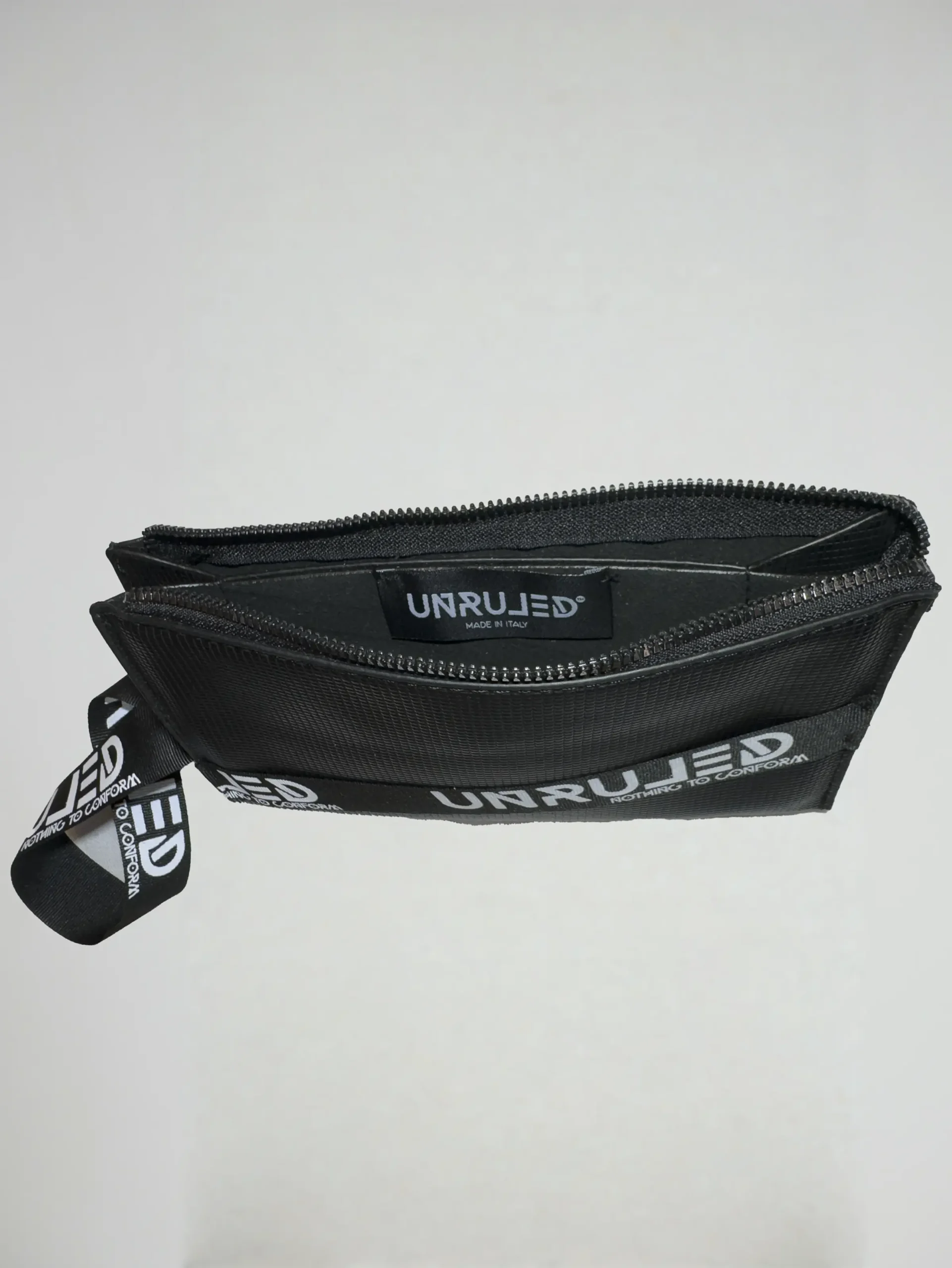Front view of the UNRULED unisex pouch featuring a minimalist contemporary design.