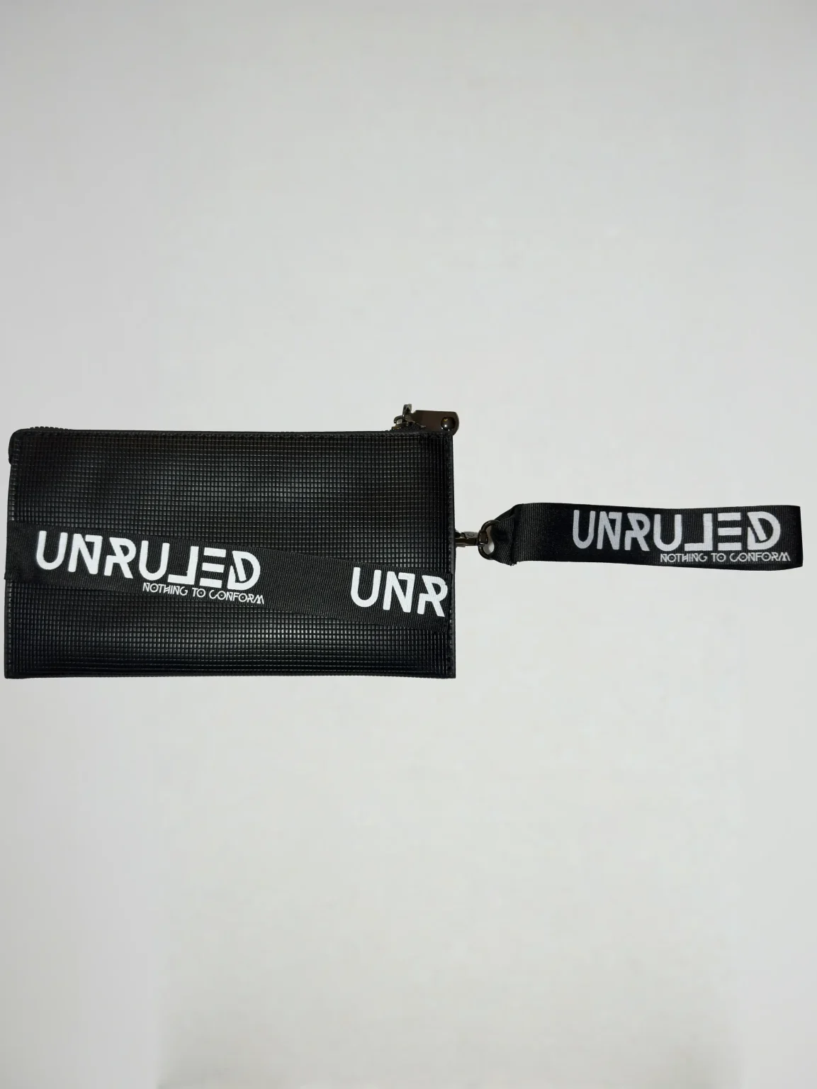 Front view of the UNRULED unisex pouch featuring a minimalist contemporary design.