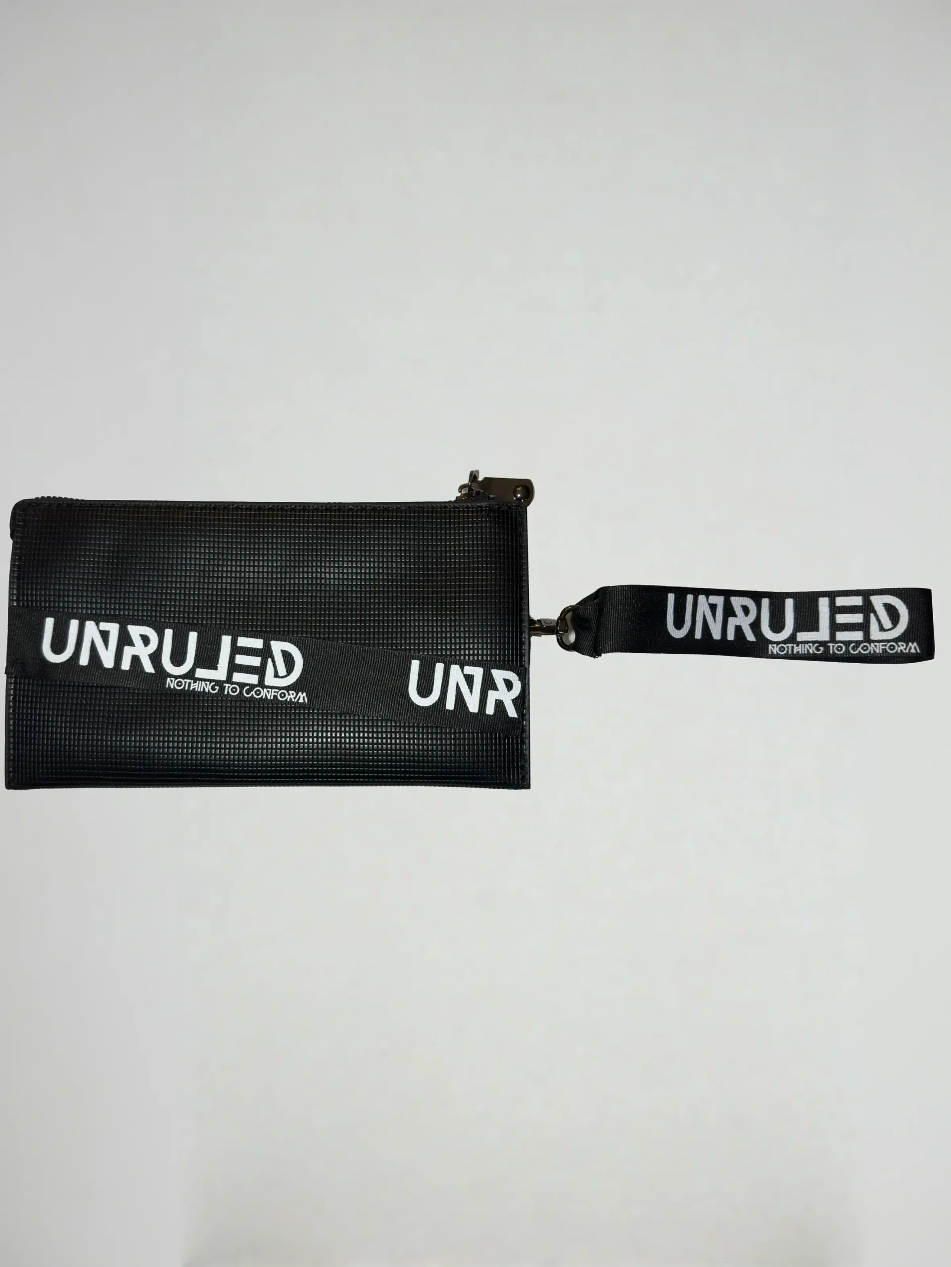 Front view of the UNRULED unisex pouch featuring a minimalist contemporary design.
