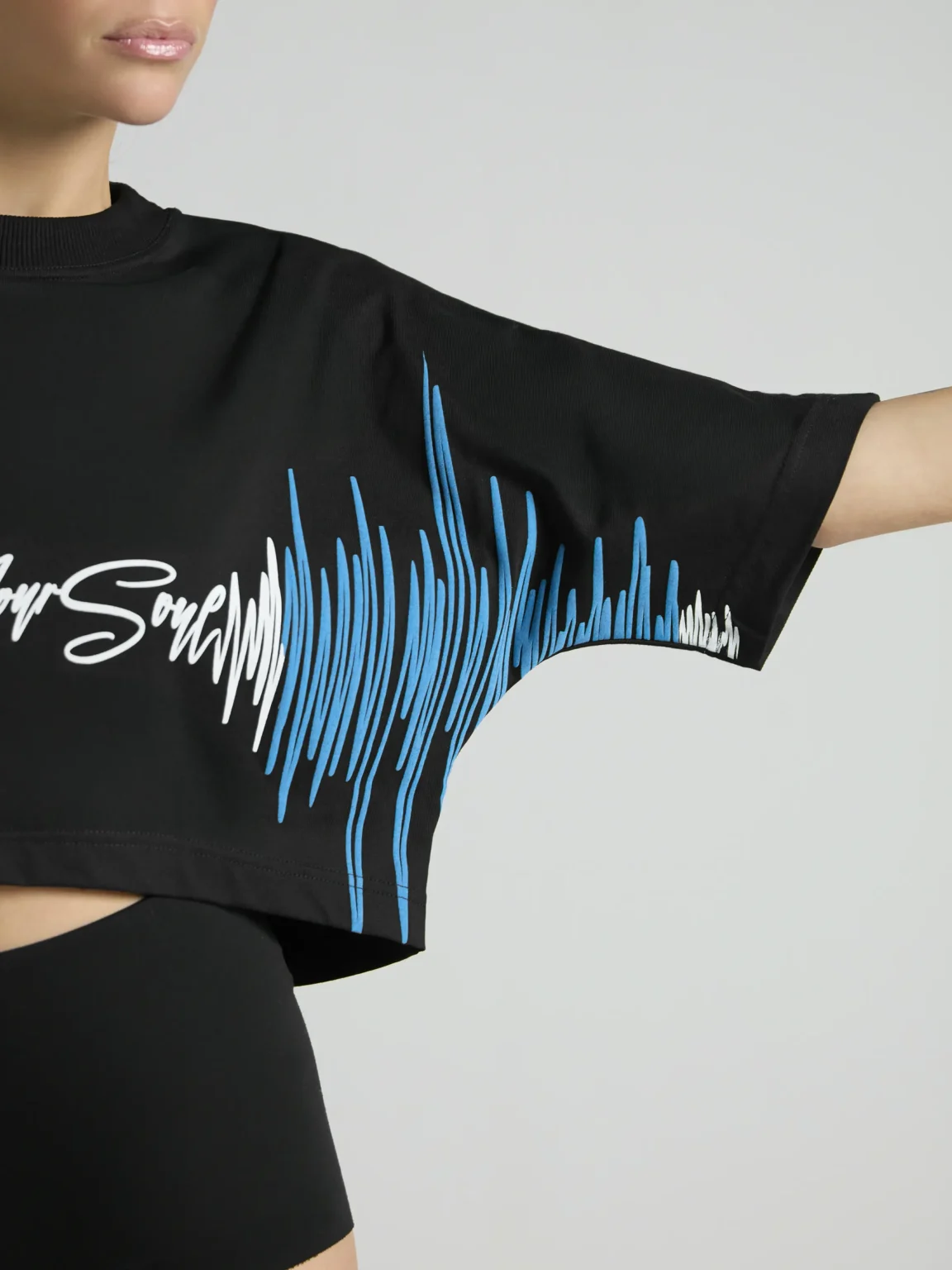Black women's cropped T-shirt from UNRULED BEAT collection with immersive DJ-inspired artwork.
