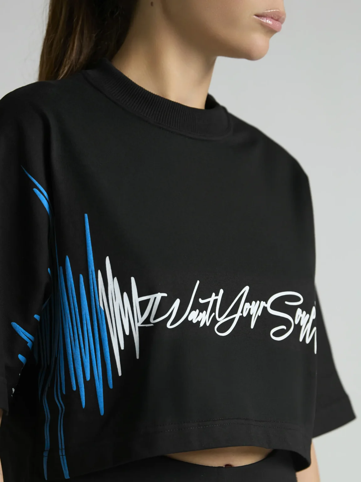 Black women's cropped T-shirt from UNRULED BEAT collection with immersive DJ-inspired artwork.