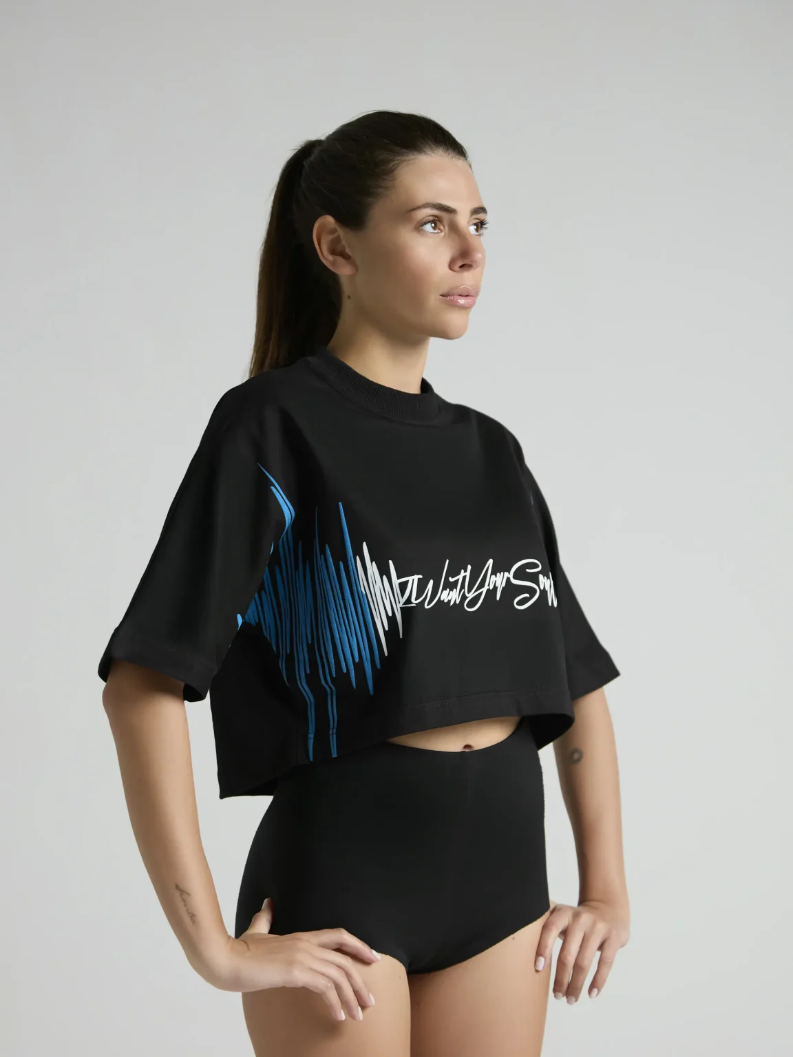 Black women's cropped T-shirt from UNRULED BEAT collection with immersive DJ-inspired artwork.