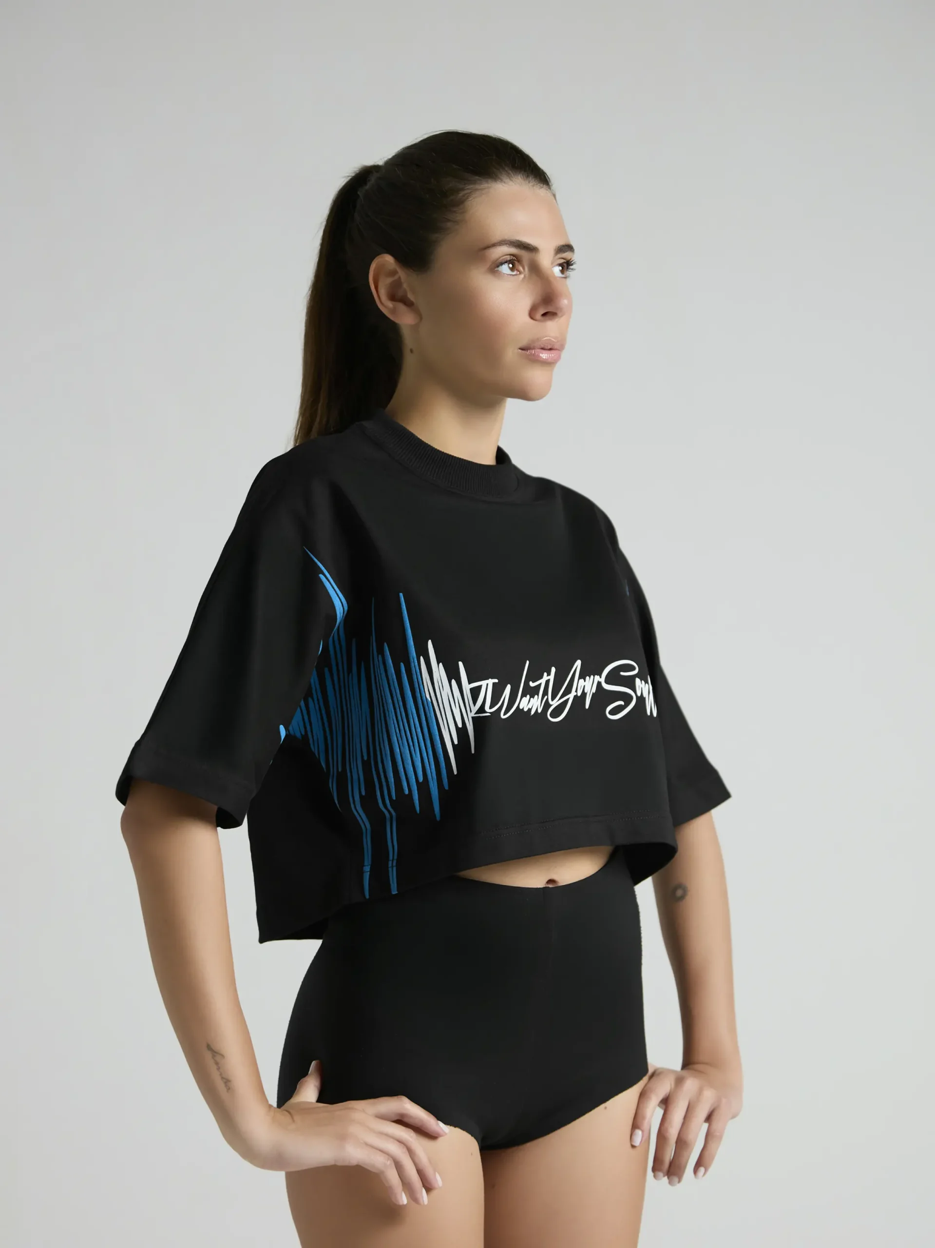 Black women's cropped T-shirt from UNRULED BEAT collection with immersive DJ-inspired artwork.