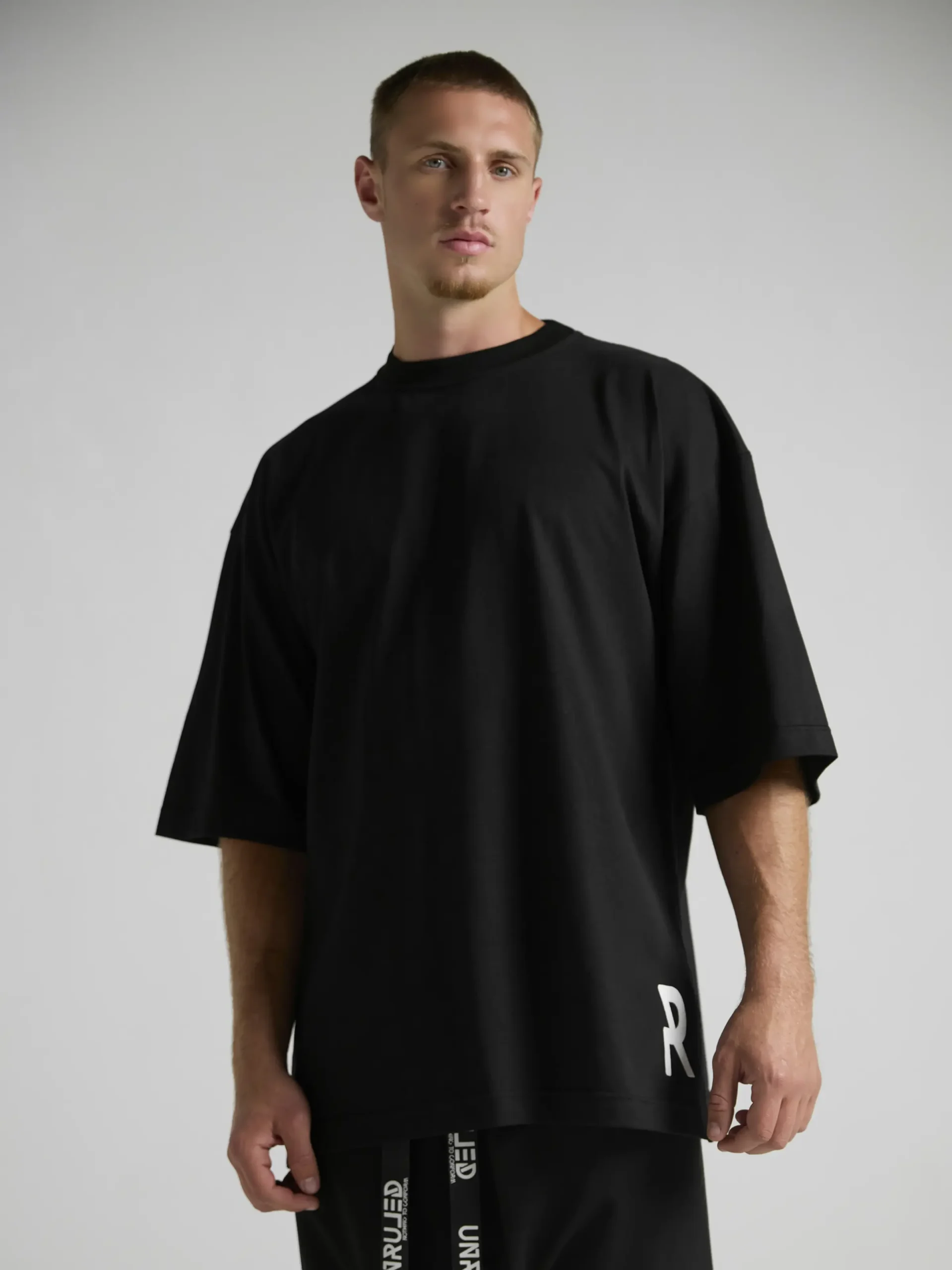 Black premium cotton T-shirt featuring an oversized architectural fit.