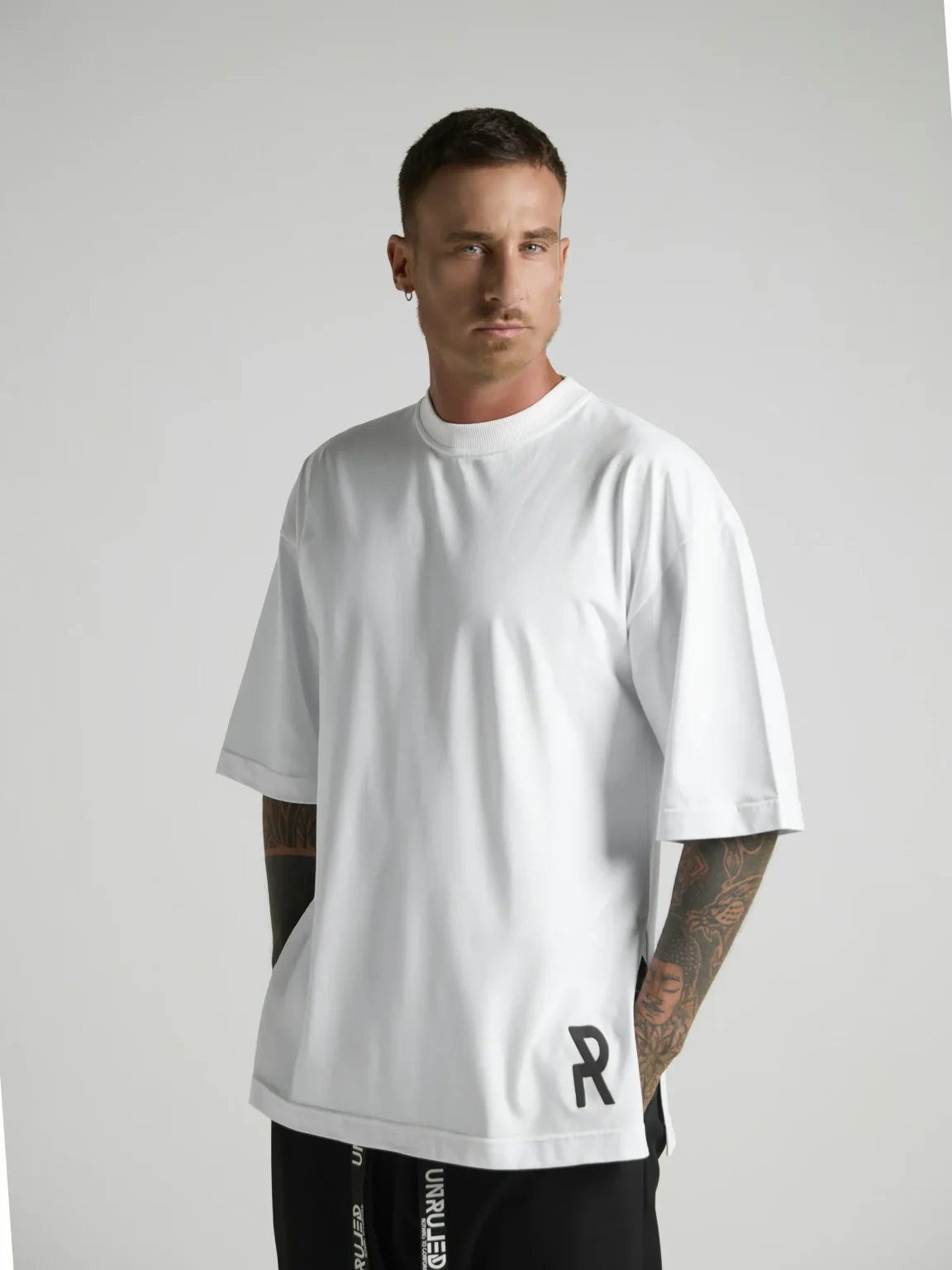 UNRULED white oversized T-shirt featuring a minimalist contemporary design.