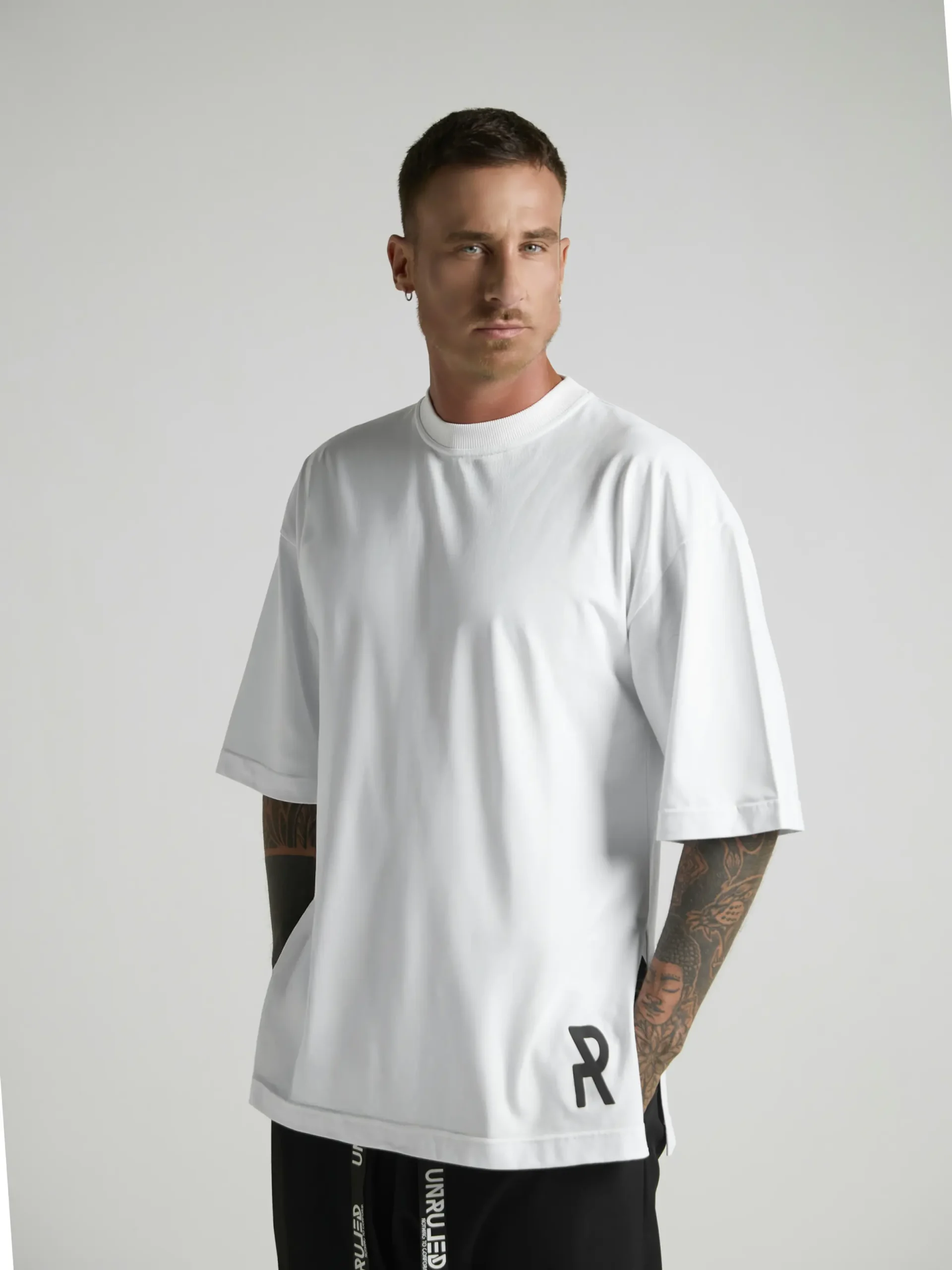 UNRULED white oversized T-shirt featuring a minimalist contemporary design.
