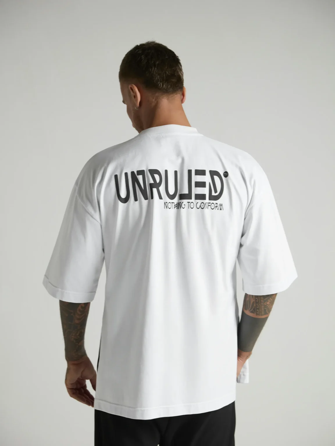 UNRULED white oversized T-shirt featuring a minimalist contemporary design.