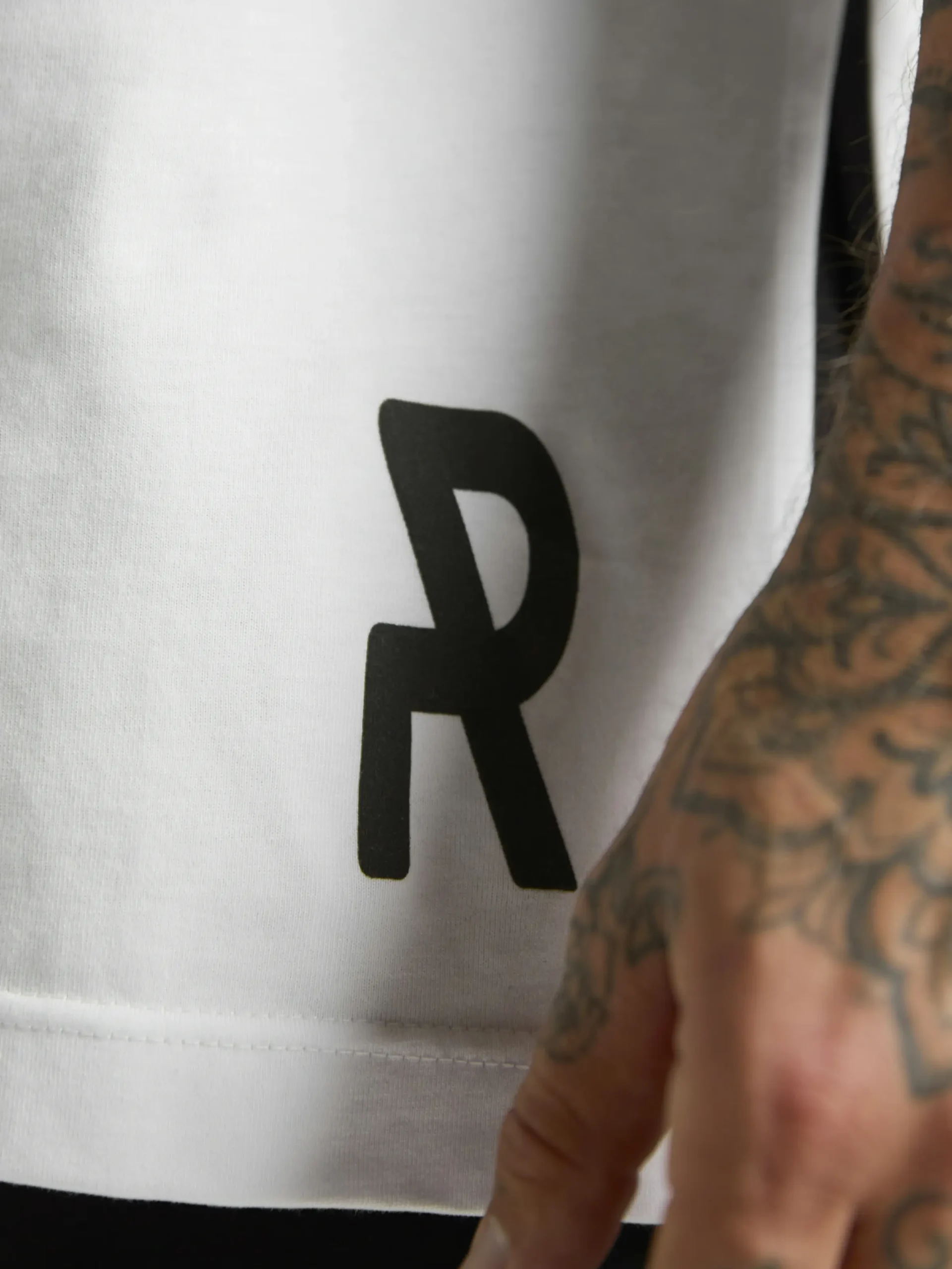 UNRULED white oversized T-shirt featuring a minimalist contemporary design.