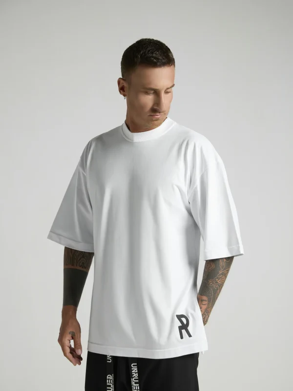 NRULED INSIDE white oversized T-shirt photographed in an editorial fashion setting.