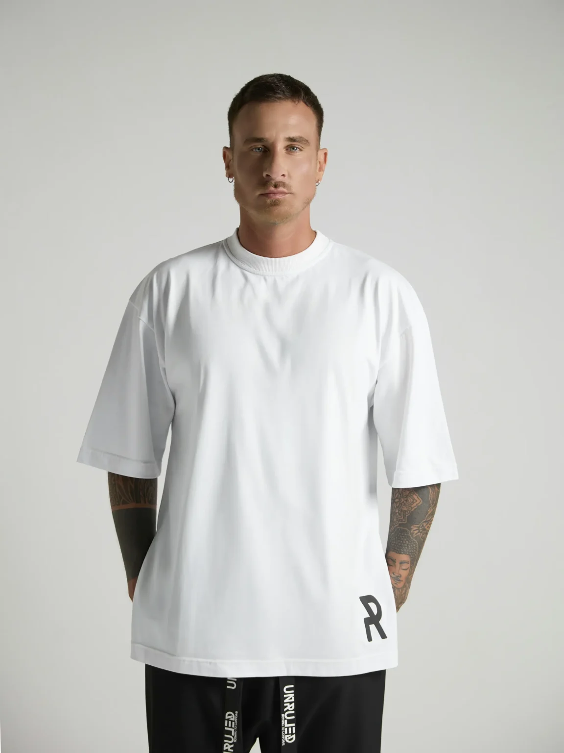 NRULED INSIDE white oversized T-shirt photographed in an editorial fashion setting.