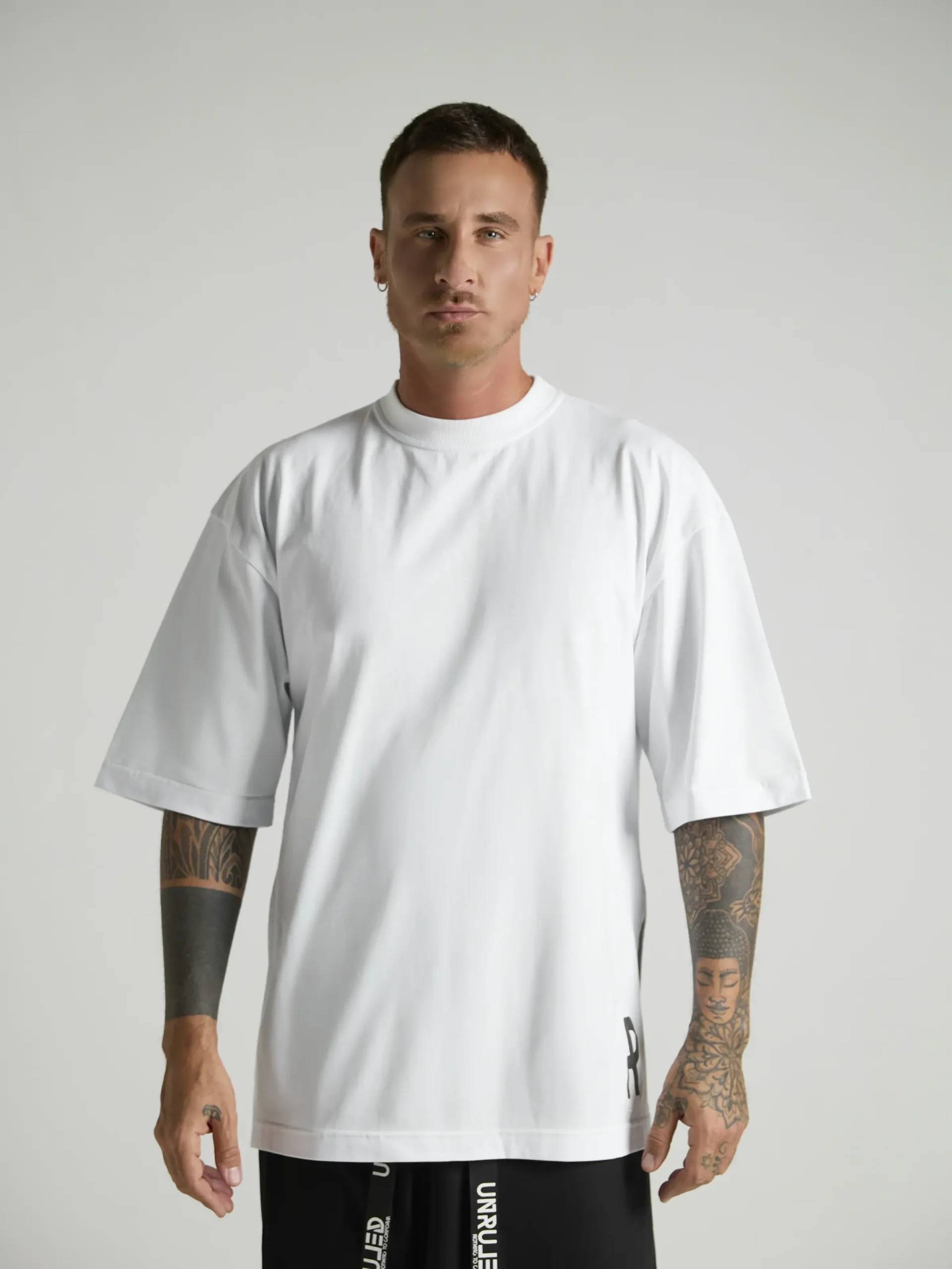 NRULED INSIDE white oversized T-shirt photographed in an editorial fashion setting.