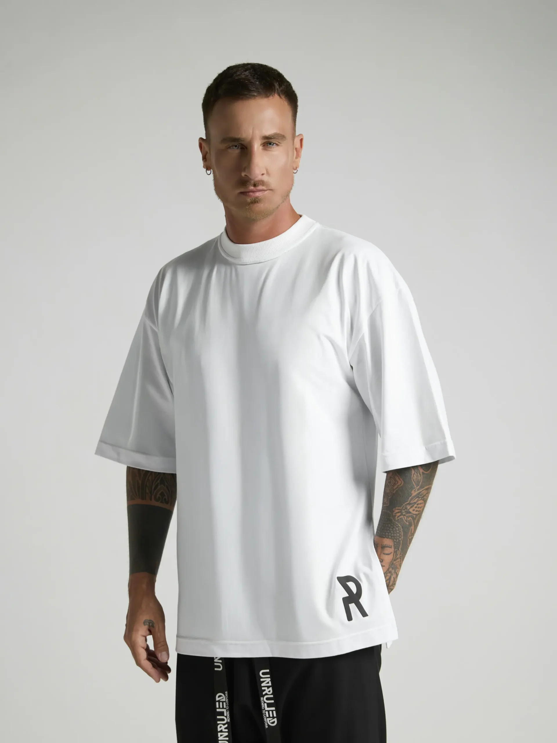 NRULED INSIDE white oversized T-shirt photographed in an editorial fashion setting.