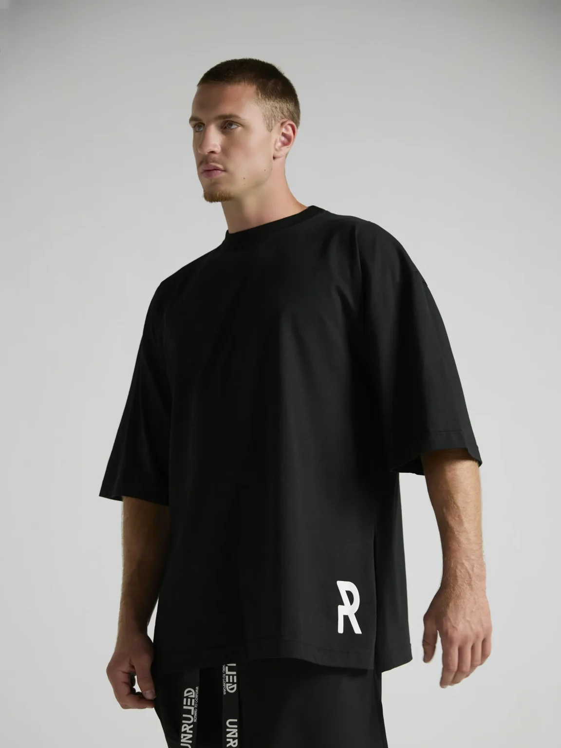en's black oversized T-shirt from the UNRULED INSIDE Collection.