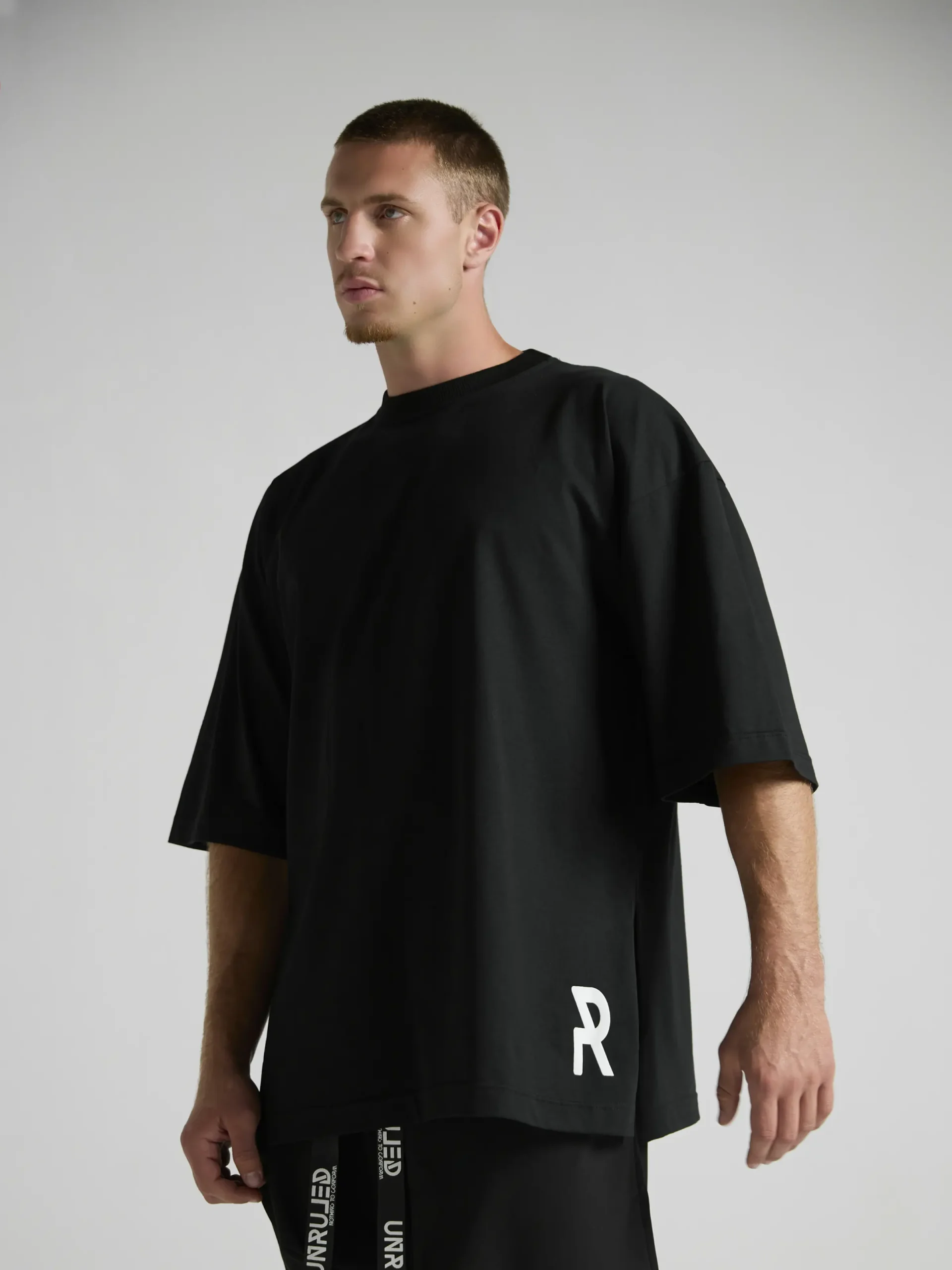 en's black oversized T-shirt from the UNRULED INSIDE Collection.