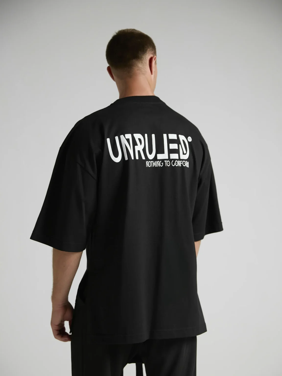 en's black oversized T-shirt from the UNRULED INSIDE Collection.