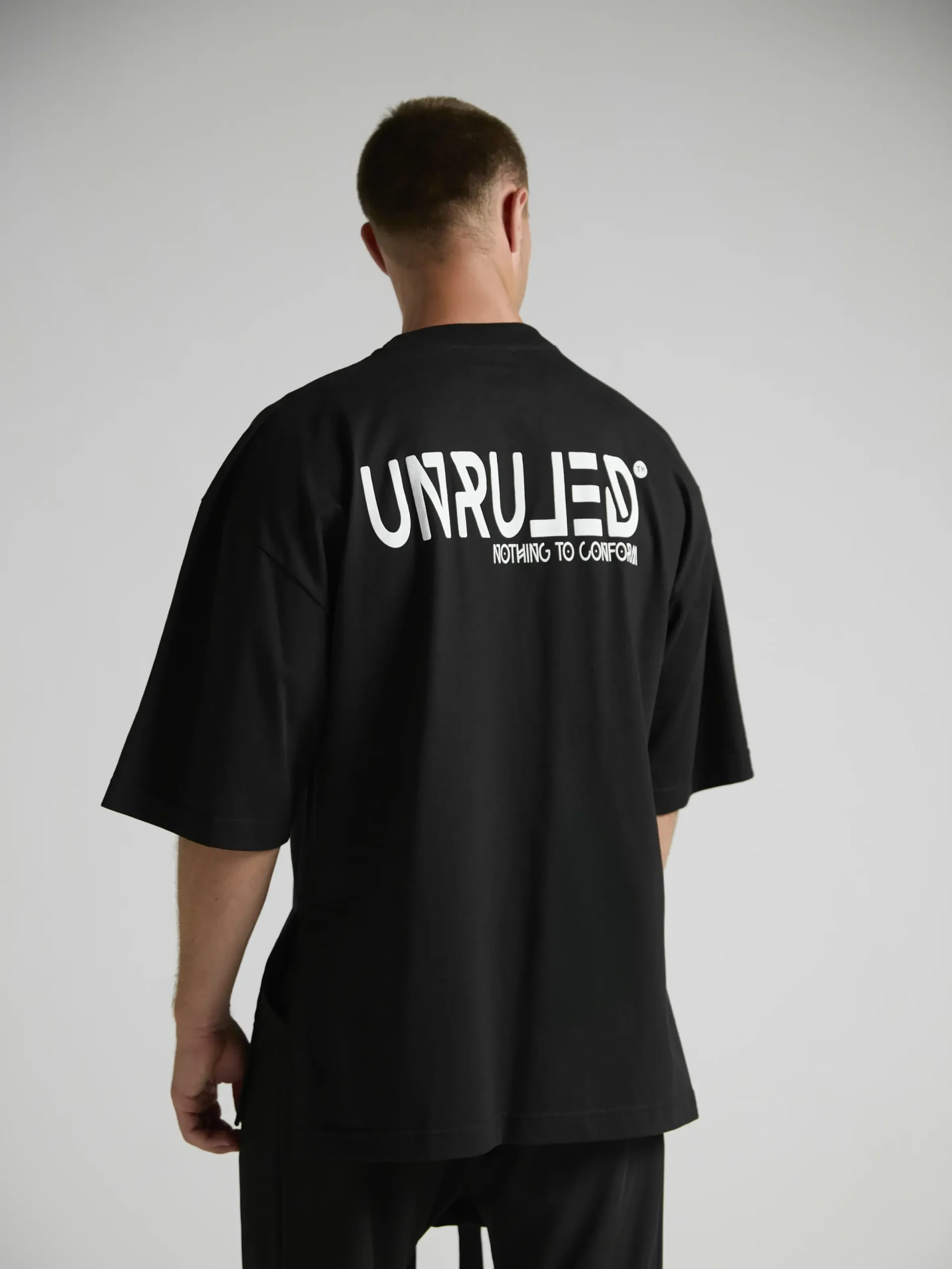 en's black oversized T-shirt from the UNRULED INSIDE Collection.